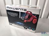 the box of a red vacuum cleaner sitting on top of a white table