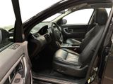 the interior of a car with the door open and the driver ' s seat down