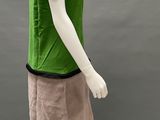 a mannequin wearing a green shirt and pink skirt