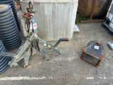a pile of old metal items on the ground next to a trash can