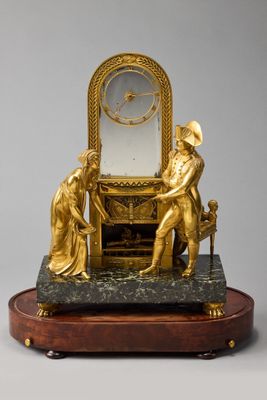a gold clock that is sitting on top of a table