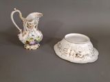 a small pitcher and a small bowl on a table