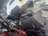 a truck with a large engine on the back of it ' s bed