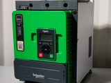 a close up of a green and black machine on a table