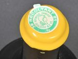 a close up of a bottle of wine with a yellow cap