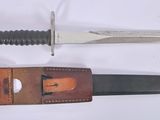 two different types of knives on a white surface