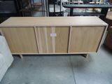 a close up of a wooden cabinet in a room with furniture in the background