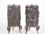 pair of antique silverware vases with dragon heads on stands