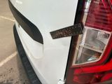 a close up of a car ' s tail light with a measuring tape on it