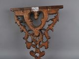 an old wooden shelf with a decorative design on it