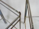 a pair of metal folding chairs sitting next to each other