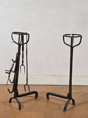 pair of wrought iron horse tacks on cast iron stands