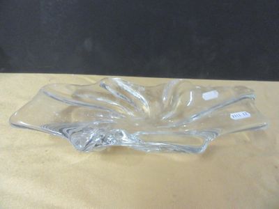 a clear glass bowl sitting on a table with a black background