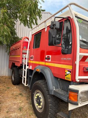 un camion de pompiers rouge garé devant un immeuble