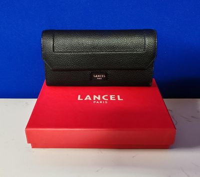 a close up of a red box with a black purse on top of it