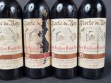 four bottles of wine are lined up on a table