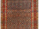 un tapis persan ancien avec une bordure bleue et rouge