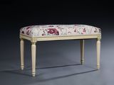 a small bench with a floral upholstered seat on it