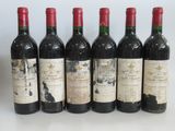 six bottles of wine are lined up on a table