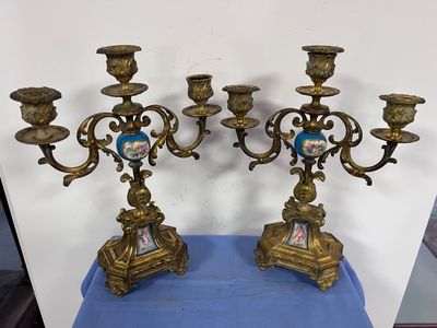 pair of antique brass candelabs with blue and white porcelain figurines