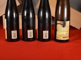 several bottles of wine are lined up on a table