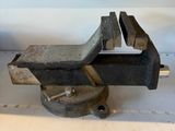 an old viset on a table with a small piece of metal