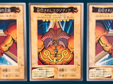 three cards of a card game with a picture of a man holding a sword