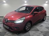 a red car parked in a garage with a checkered floor