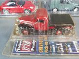 three toy cars that are in plastic cases on a table