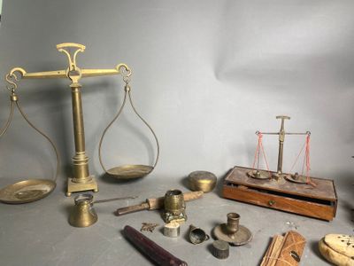 a scale, a hammer, a clock, and other objects on a table