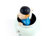 a small toy that is sitting in a cup
