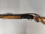 an old shotgun with a wooden handle on a white background