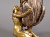 bronze statue of a woman holding a flower with a man on it