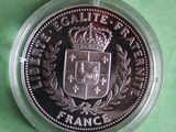 the coin is in a plastic container on a green surface