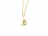 a gold necklace with an om symbol on it