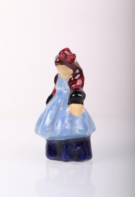 a small figurine of a woman in a blue dress