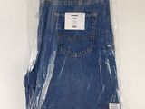 the back of a pair of blue jeans wrapped in plastic