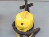 a yellow vacuum cleaner sitting on the floor in a room