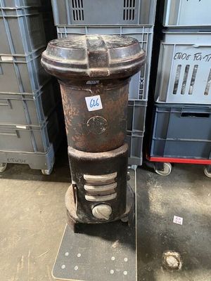 an old fire hydrant in a warehouse with crates in the background