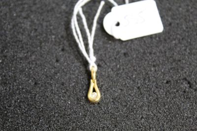 a white tag with a gold tear hanging from it