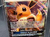 a pokemon card in a clear box on a table