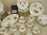 many plates and cups and saucers on the table