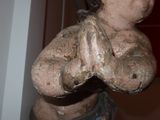 a small statue of a boy holding his hands together
