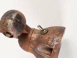 an old rusted metal object on a white surface