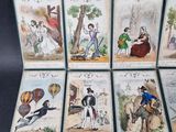 six cards with pictures of people and animals on them on a black surface
