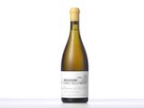 the bottle of white wine is sitting on the table