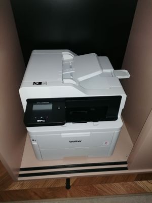 a printer that is sitting on top of a cabinet