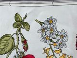 a picture of a table cloth with a bunch of flowers on it