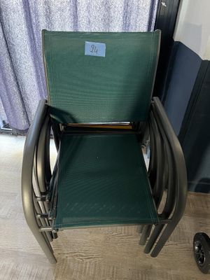 une chaise verte placée devant une fenêtre