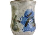 a blue and white vase with a blue flower on it